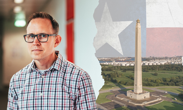 Dr. Torget looks at the camera; to the right is the San Jacinto Monument.