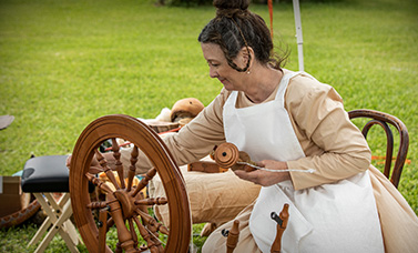 Living history reenactor demonstrating spinning.