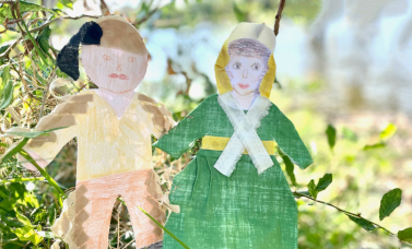 Two paper dolls are dressed as a man and woman of the 1830s.