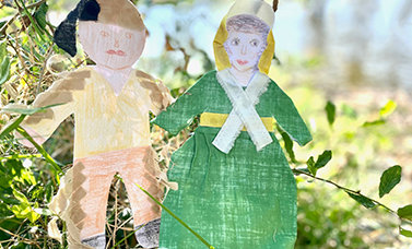 A male and a female paper doll care brightly colored.