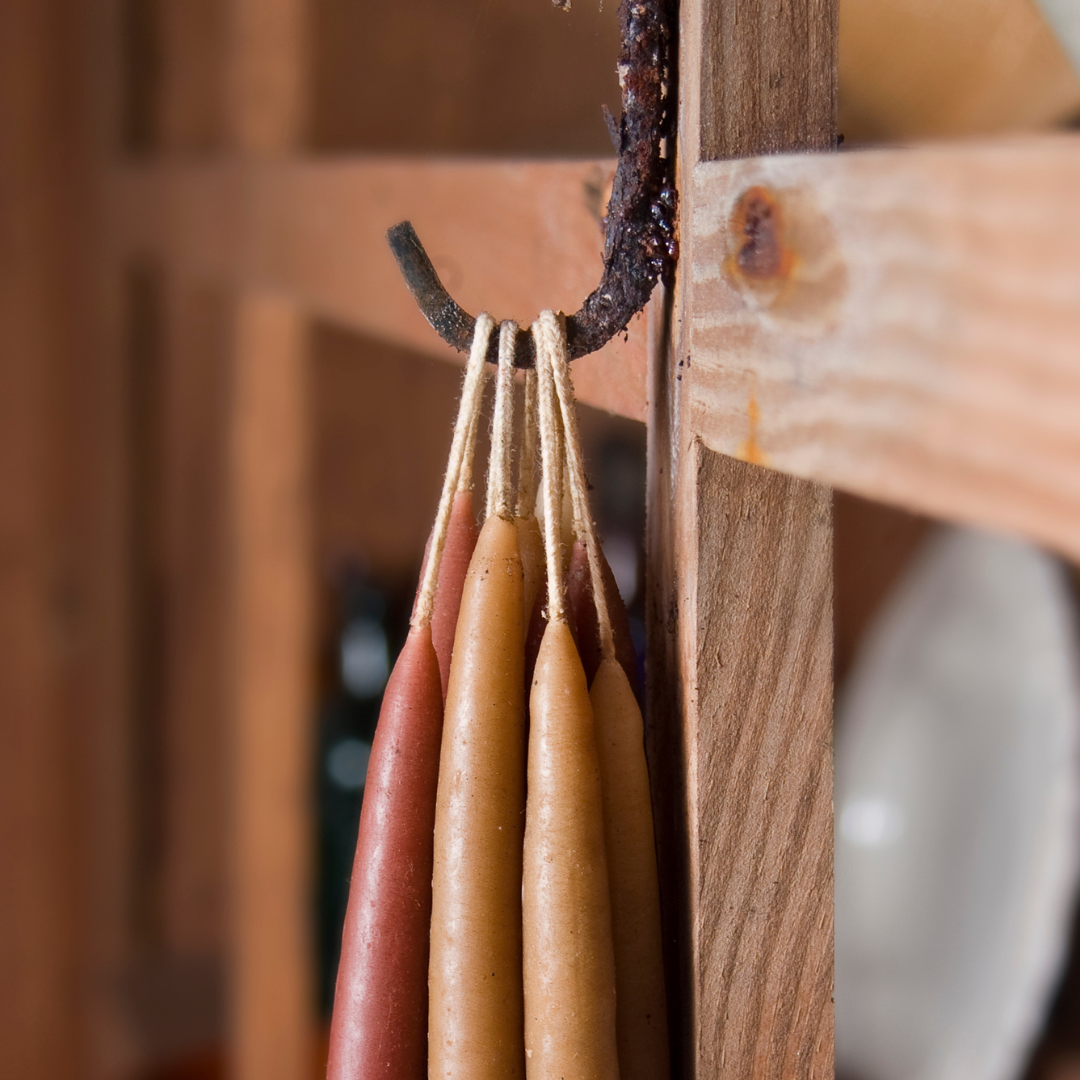 Molded candles hang from a hook.