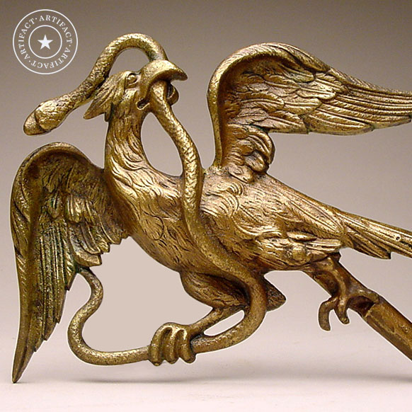 A golden eagle figure with it's wings spread and a snake in it's mouth