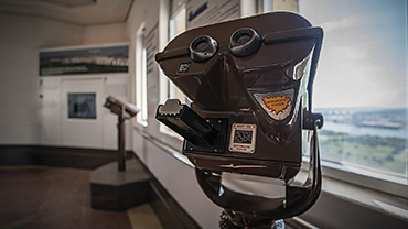 A photo showing a viewing telescope within the room with a view